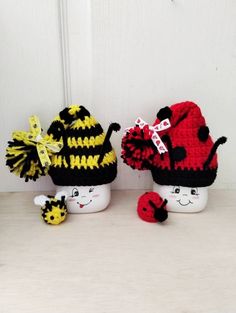 three knitted hats sitting next to each other on top of a white countertop