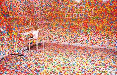 a room filled with lots of different colored confetti on the walls and floor