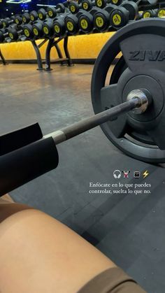 a person holding a barbell in the gym