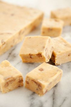 several pieces of peanut butter fudge on a marble surface