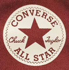 the converse all star logo is shown on a maroon sweater with white stitching and red trim