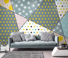 a couch sitting in front of a wall covered in polka dotty and yellow circles