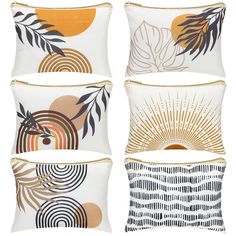 four pillows with different designs on them, one is orange and the other is white