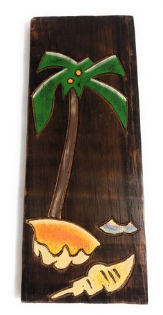 a piece of wood with a palm tree on it