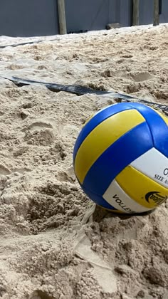 a beach volleyball ball is in the sand