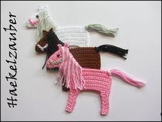 three crocheted horses sitting on top of a white table next to each other