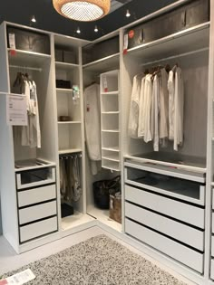 an empty walk in closet with white drawers