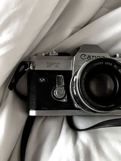 a camera sitting on top of a white blanket