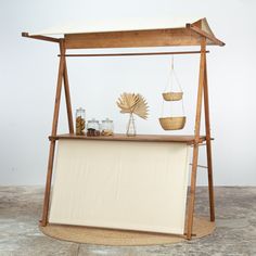 an old fashioned display case with items on it's sides and hanging from the ceiling