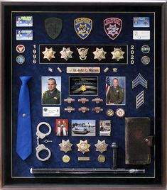 a police officer's shadow box with badges and other items