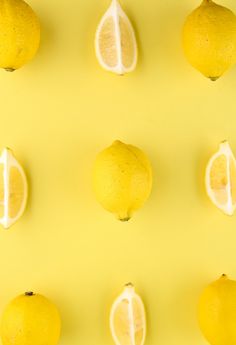 several lemons are arranged on a yellow background