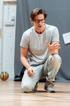 a man sitting on the floor with his hands out