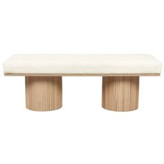 a white bench sitting on top of a wooden table