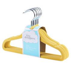 three yellow clothes hangers with the tag on top of each one that says tinydreemers