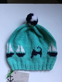 "Hand knit soft non itch wool baby hat measuring 17\" unstretched at rest circumference and 8\" brim to crown. Optimal sizing measuring child's head but should fit \"average\" 12-24 month old. Teal, navy & white.   Navy & white Pom." Warm Adjustable Hats For Playtime, Playful Warm Hat For Playtime, Playful Beanie Hat For Playtime, Playful Beanie For Playtime, Playful Knitted Cap, Playful Knit Hat One Size Fits Most, Playful Knitted Bonnet, One Size, Playful Hand-knitted Beanie, Playful Hand Knitted Hat