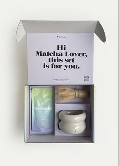 the box contains two mugs, a brush and an advertiser's message