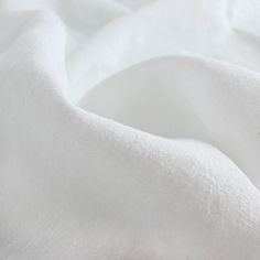 a close up view of a white sheet that has been made to look like fabric