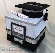 a graduation cap and diploma sitting on top of a box