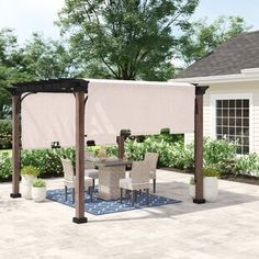 a patio with a table and chairs under an awning