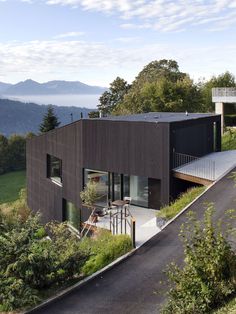 the house is surrounded by trees and mountains