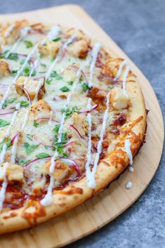 a pizza sitting on top of a wooden cutting board