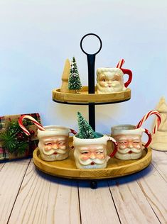 three tiered tray with santa mugs and candy canes