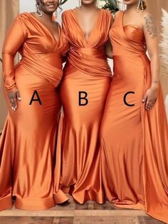 three women in orange dresses standing next to each other with the letters abc on them