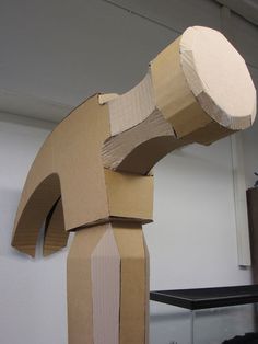 an animal made out of cardboard sitting on top of a table