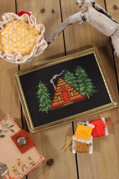 a wooden table topped with different types of needles and other things on top of it