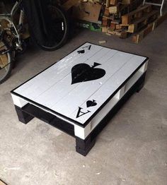 a coffee table with two hearts painted on the top and one heart in the middle