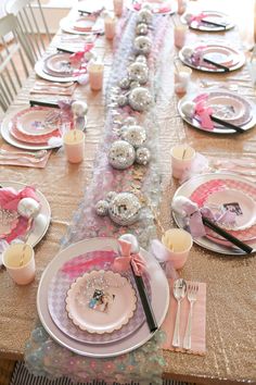 the table is set with pink and white plates