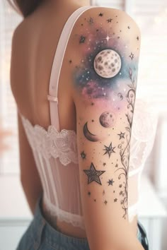 a woman's arm with stars and planets on it