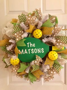 a green and yellow wreath with the words the matsons written in white on it