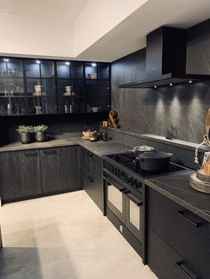 a kitchen with black cabinets and an oven