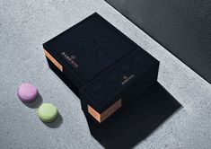 three macaroons sitting on the ground next to each other in front of a black box