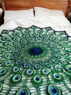 there is a large peacock blanket on the bed