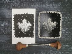 two square coasters with ghost images on them