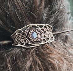 a close up view of a hair piece with beads on it's back end