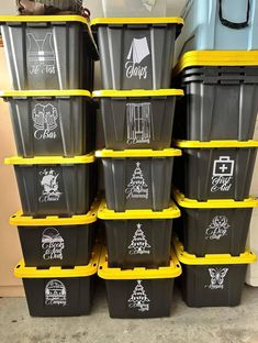 a stack of black and yellow plastic containers sitting on top of a carpeted floor