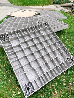 two gray trays sitting on top of green grass