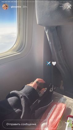 someone's hand on the seat of an airplane