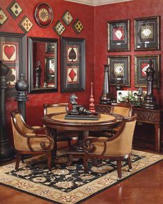 a dining room with red walls and pictures on the wall, including an oval table surrounded by chairs