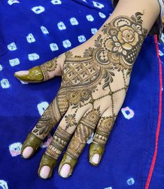 a woman's hand with henna tattoos on it