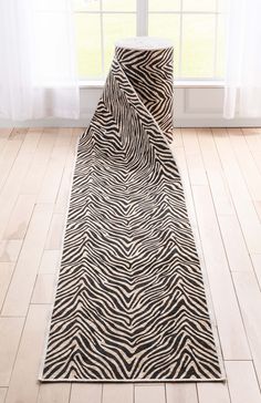 a black and white zebra print rug in front of a window