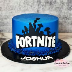 a blue and black cake with the word fortnite on it's side