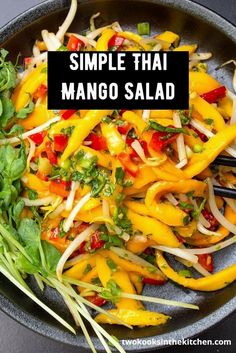 a skillet filled with mango salad on top of a table