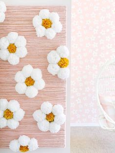 white and yellow flowers are arranged on a pink background