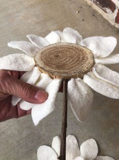 a person holding a flower made out of fabric