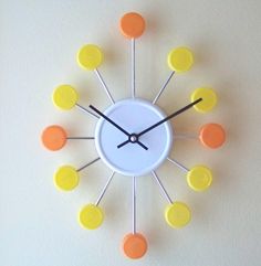 a clock with yellow and orange circles around it