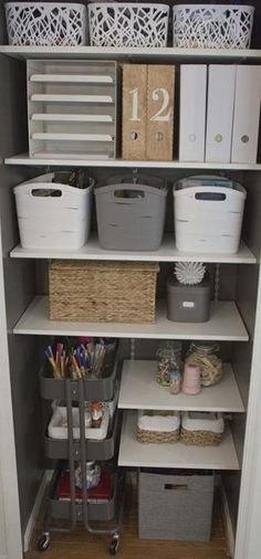 an organized closet with baskets, bins and other items on the shelves in it